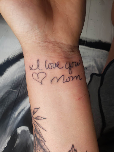 Explore rose hand tattoo ideas, creative tattoo ideas in Decatur, available at Exclusive Ink Tattoos & Body Piercings 22nd & Wood