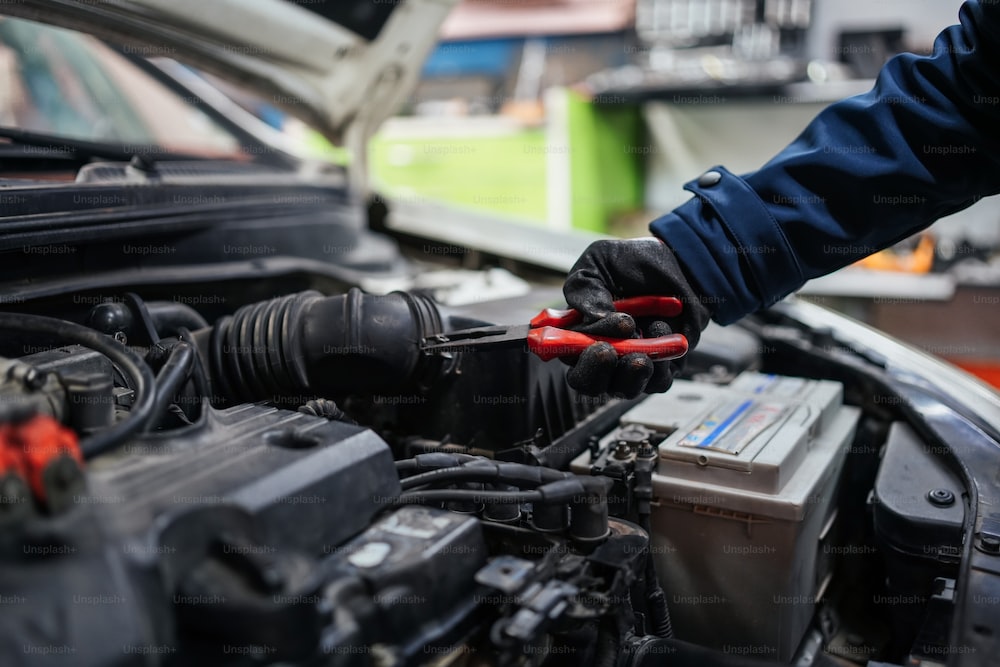 A man is working on a car engine - Phoenix Diesel Repair