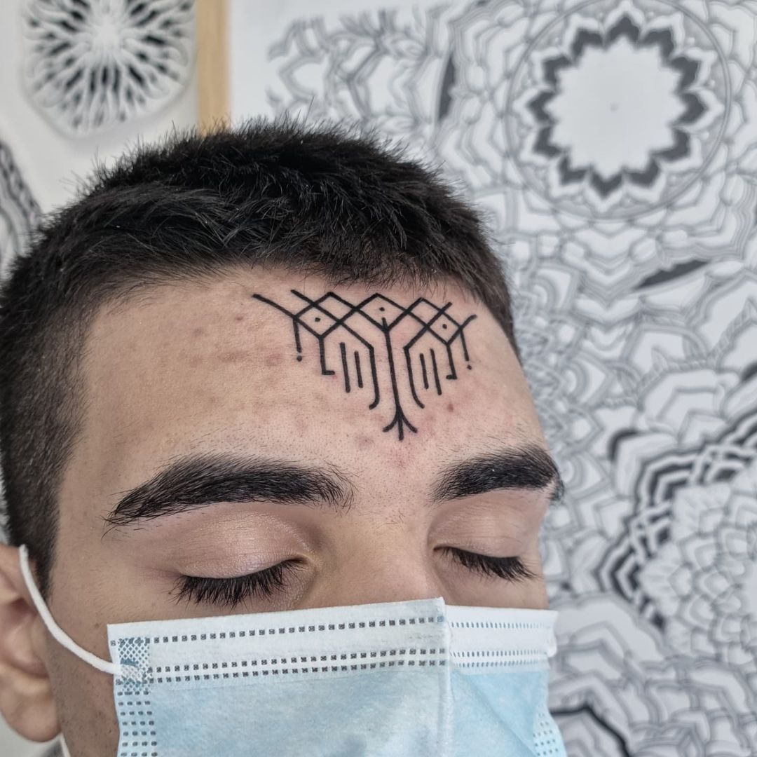 black tattoo on forehead