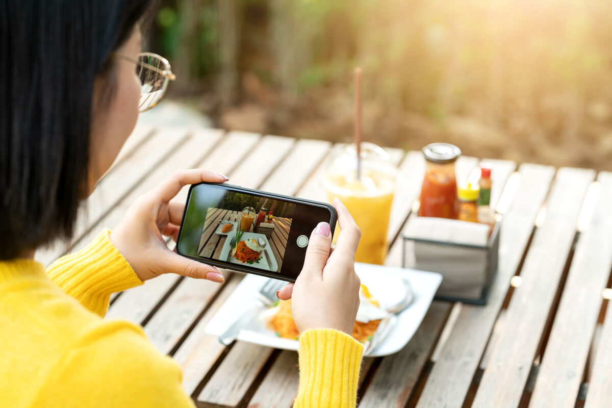 Micro vs macro influencers: person taking a photo of her food using her phone