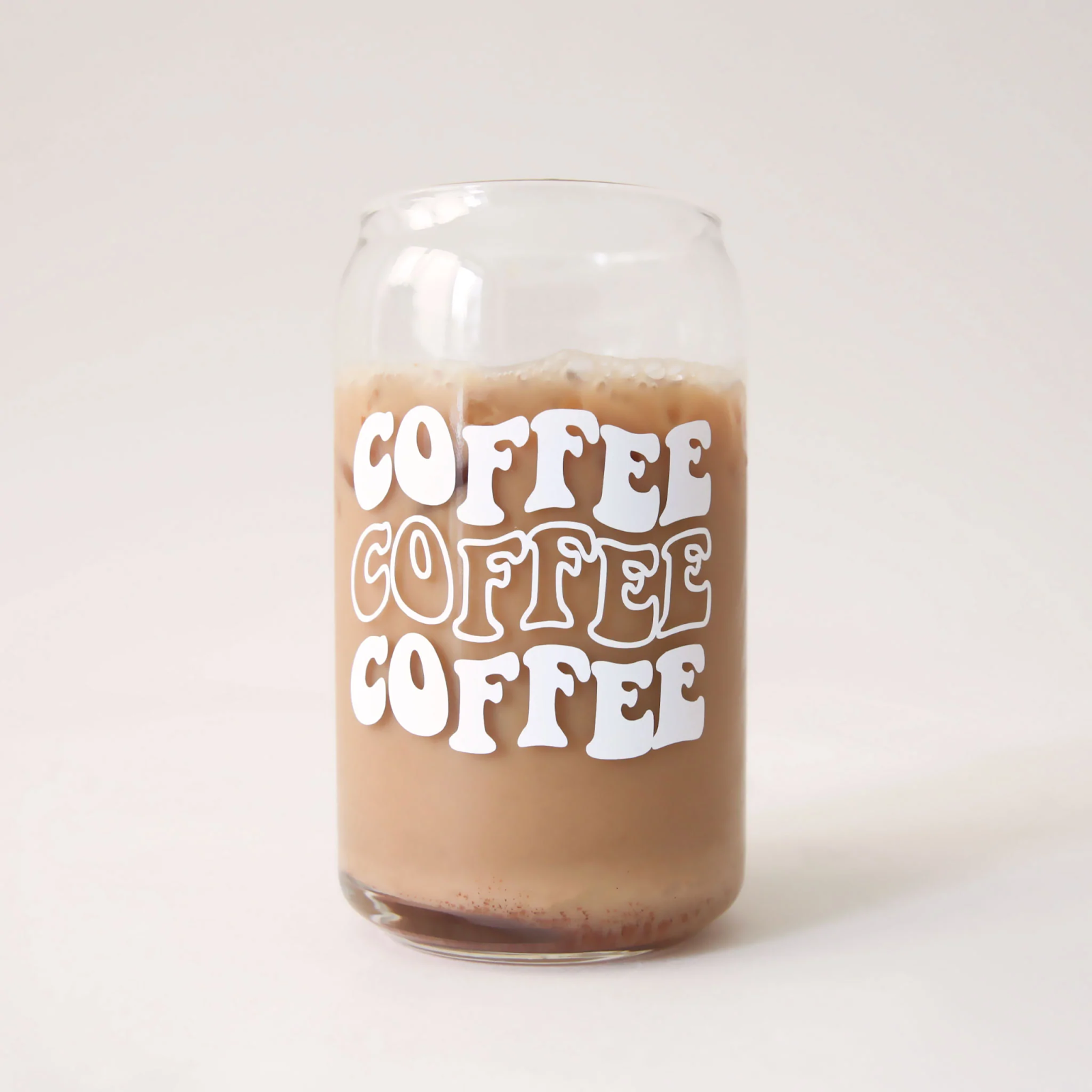 glass cup that says "coffee coffee coffee" in a retro font