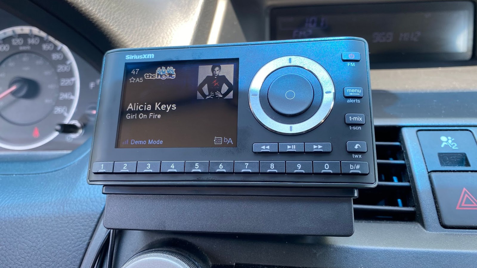 SiriusXM Onyx Plus satellite radio demo mode showing the title, band, and album art of a song.