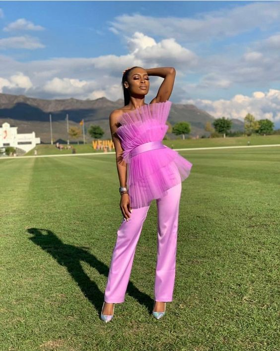 a lady wearing pink two-piece pants and pleated top