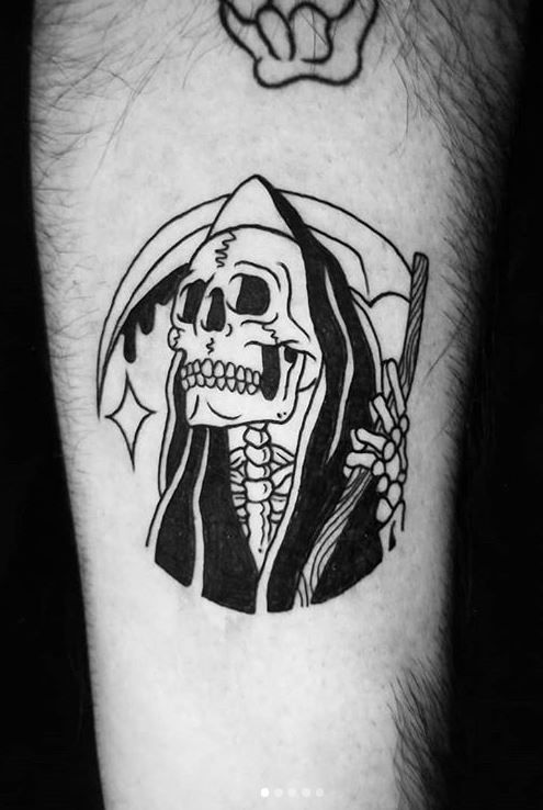 Picture  showing a guy rocking the grim reaper tattoo