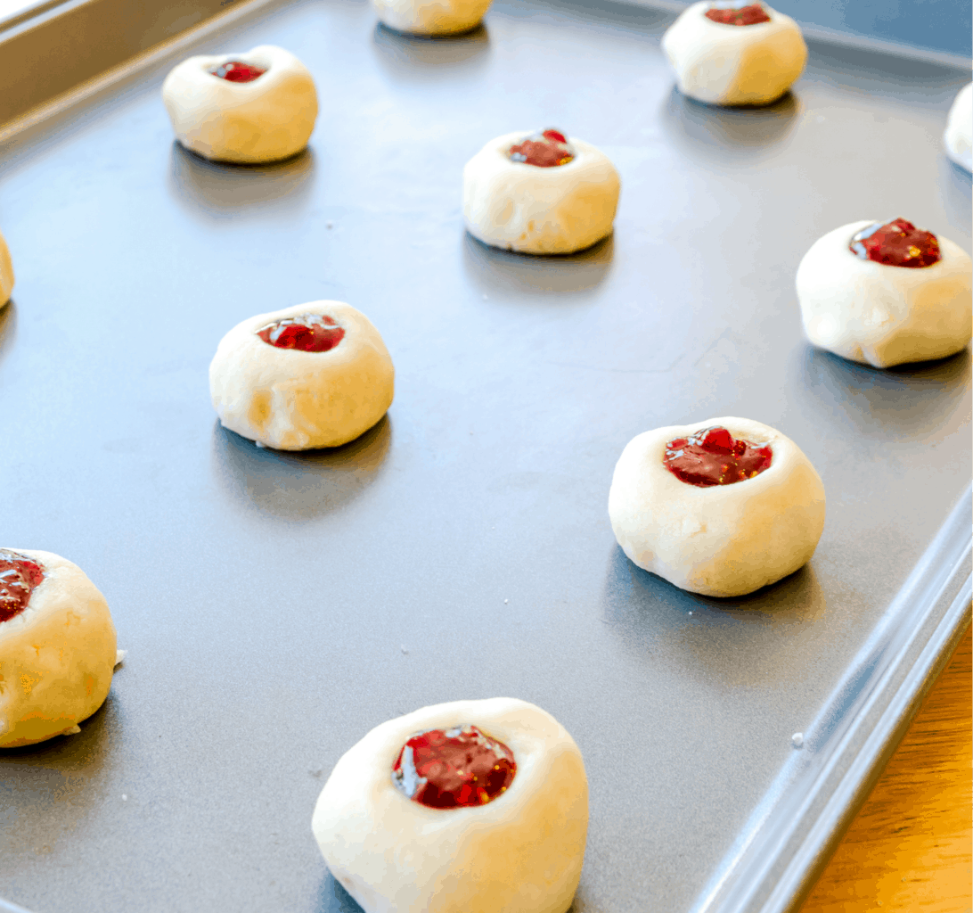 keto thumbprint cookies ready to bake on a cookie sheet