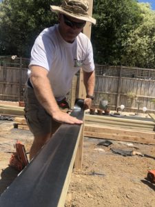 deck builder installing joist tape on Trex RainEscape drainage system