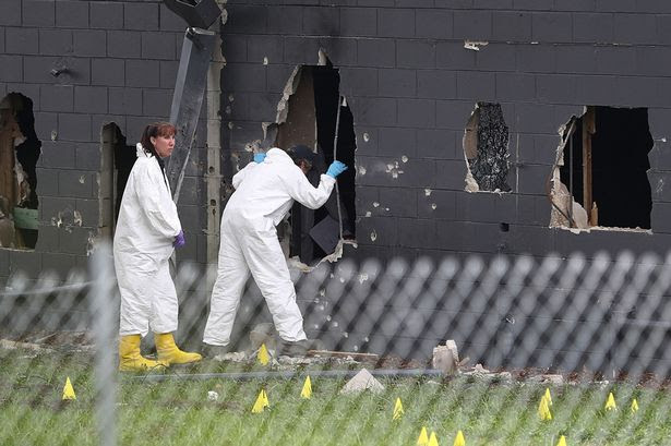 FBI agents investigate near the damaged rear wall of the Pulse Nightclub where Omar Mateen allegedly killed at least 50 people