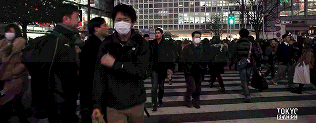 Surreal reversed footage of a man walking backwards in Tokyo