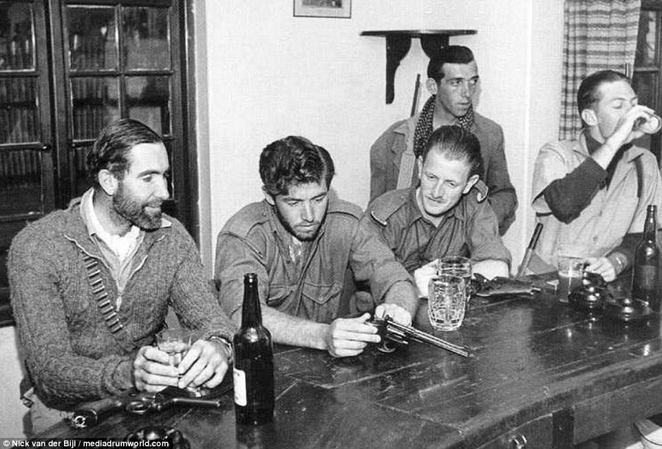 Members of the Kenya Regiment sit and enjoy a drink together following what would no doubt have been a stressful and life-threatening patrol. The never before seen images have revealed the harsh and treacherous landscapes British soldiers had to endure during the Kenya Emergency as they sought to suppress the Mau Mau Rebellion