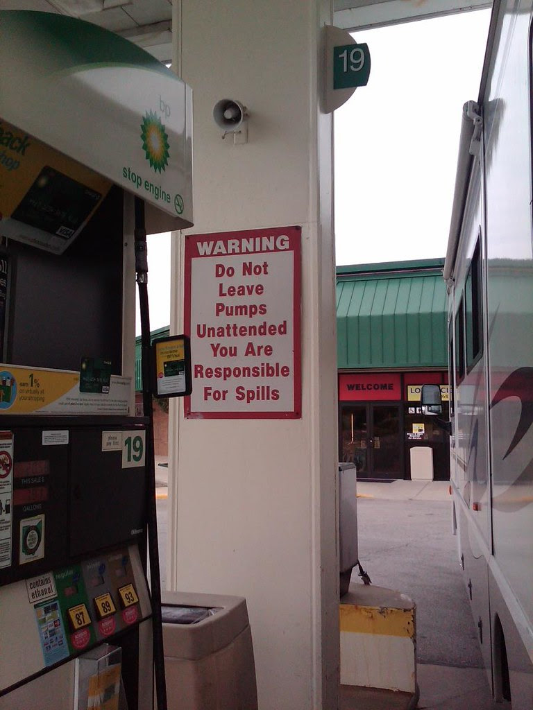 gas station sign, do not leave pumps unattended, oil spill, 