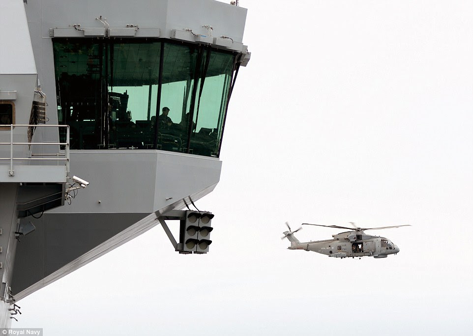 The Merlin helicopter circled the vessel before landing on its four acre flight deck. The aircraft carrier will eventually be able to operate up to 36 F-35 Lightning II jets and 14 helicopters 
