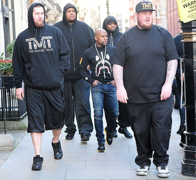 Floyd Mayweather's bodyguards tower over him on luxury shopping spree in London