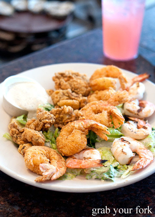 caesar salad with grilled shrimp fried shrimp and fried oysters at felix's restaurant and oyster bar new orleans louisiana