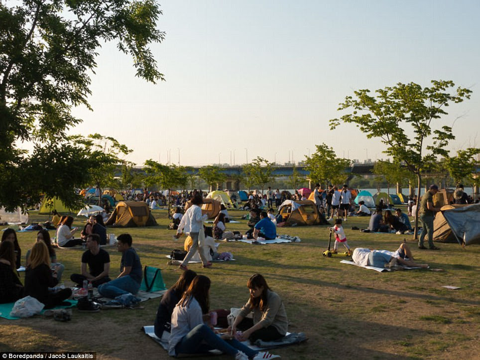 Laukaitis says this photo documents what people get up to in the free time in South Korea, with groups of friends relaxing in the park