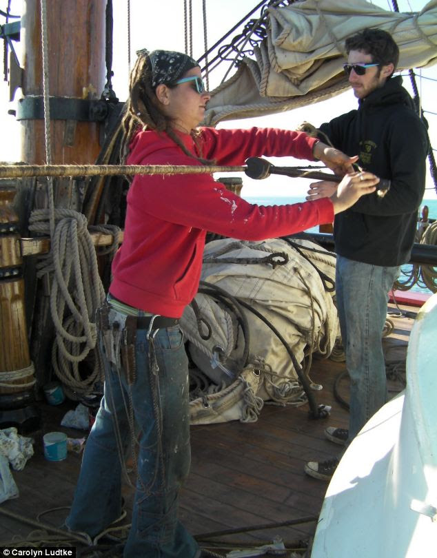 Before the storm: Bosun Laura Groves and Chris Malloon work on the rigging in 2010 as the Bounty sailed between New Brunswick and Maine for a haul out. Two crew members died in the storm but 14 survived