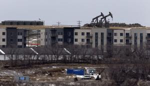 In this Wednesday, Dec. 17, 2014 photo, oil pump jacks …