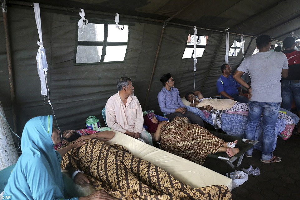Earthquake victims receive medical treatment at a makeshift a hospital in Pidie, Aceh province