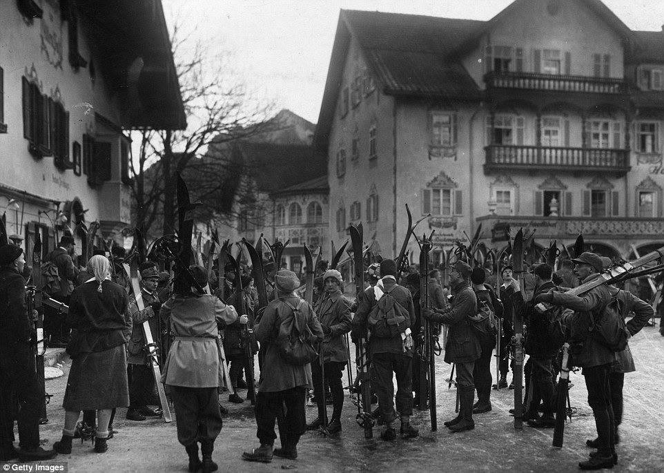 A group of tourists in Oberammergau waiting to go skiing in Bavaria. In 1928, skiing attire looked nothing like the uniforms of today