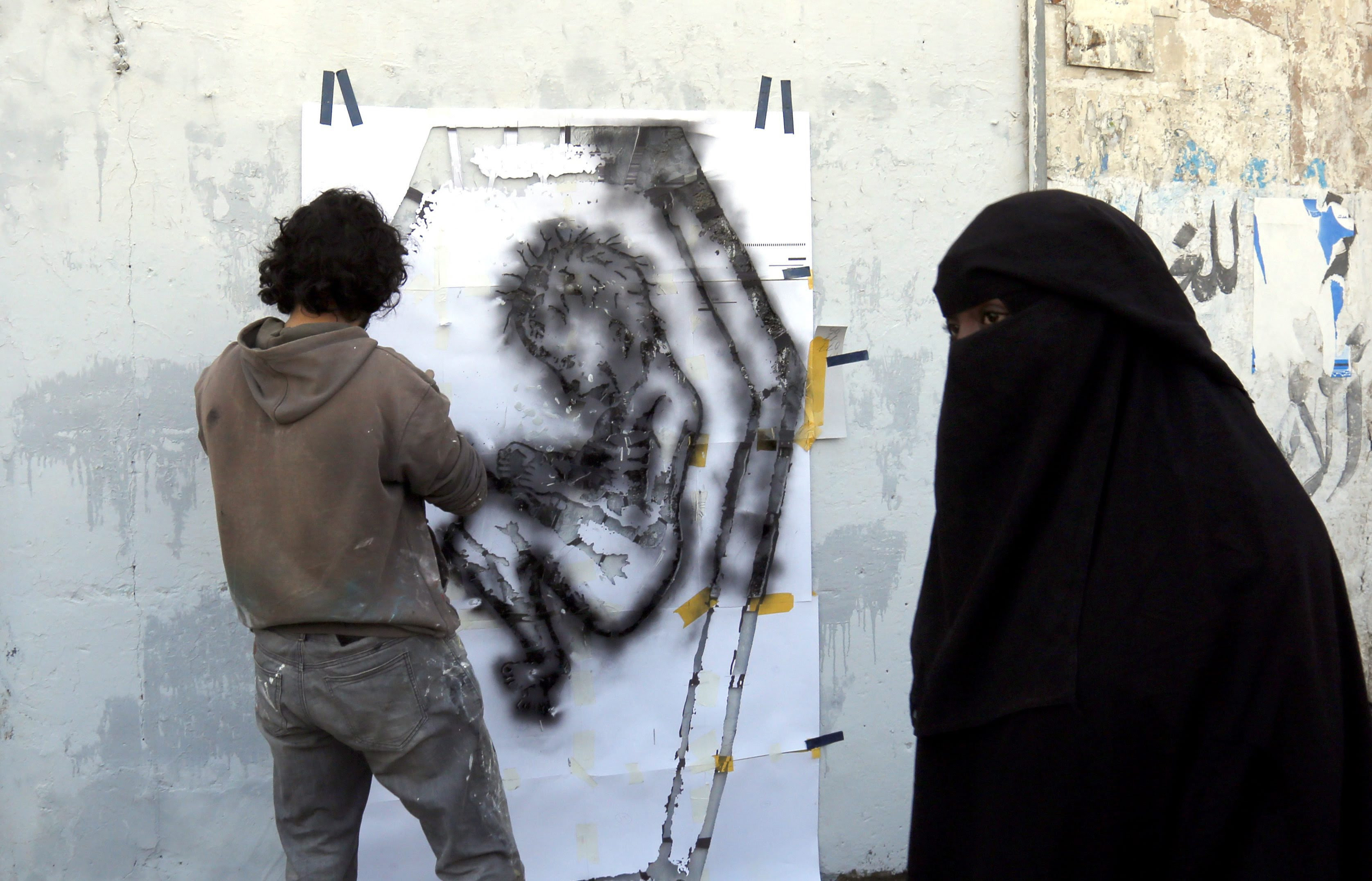 Yemeni artist spraying a graffiti on a wall in protest against the ongoing conflict and the worsening economic situation in the war-affected country, in Sanaâ€™a, Yemen, 20 October 2016. According to reports, since March 2015, ongoing conflict and the Saudi-led airstrike campaign in Yemen have left 21.2 million - 82 percent of Yemenâ€™s population - in dire need of humanitarian aid, including 9.9 million children.  EPA/YAHYA ARHAB