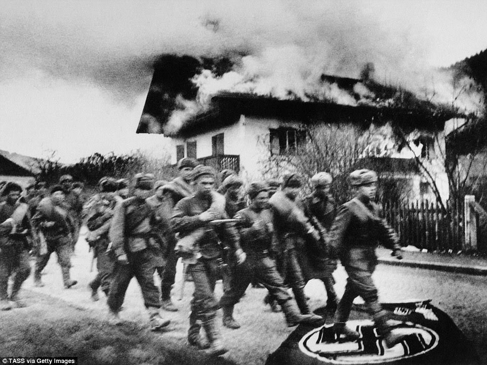 Soldiers of the Red Army trample over a Nazi flag as they march to Berlin - the Battle of Berlin, from April 16 to May 2 1945, was the last major offensive of the Second World War