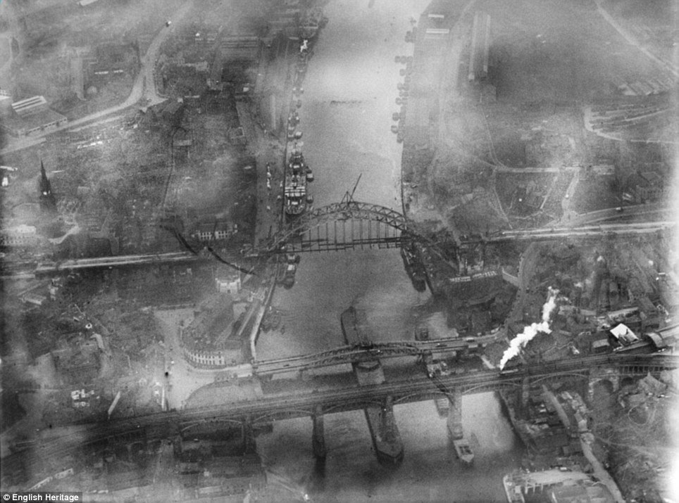 Fog on the Tyne: The Tyne Bridge under construction in Newcastle in 1928 as coal ships and other vessels dock at the riverside
