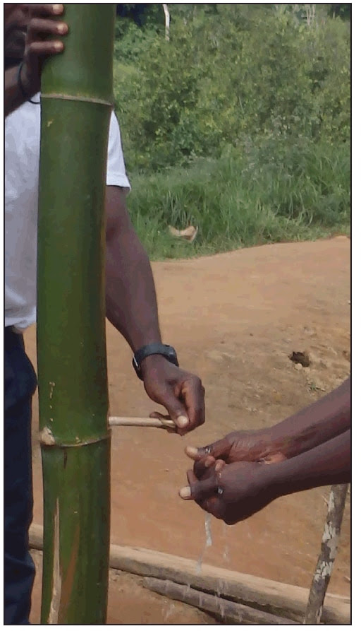 The figure above is a picture of residents using a bamboo hand washing station in Liberia. The stations were erected during August 2014 to improve health care practices at entrances to hospitals, county checkpoints, and in towns in four Liberian counties amid the Ebola outbreak.
