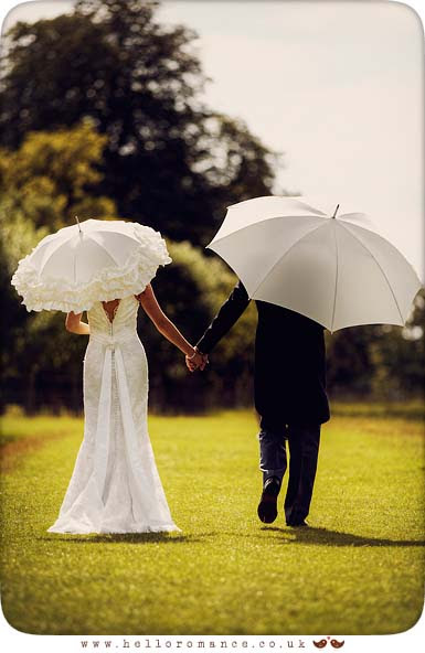 Bride and Groom with umbrellas at Helmingham Hall Wedding Photography - Katie and Greg - Hello Romance Wedding Photography Ipswich Suffolk