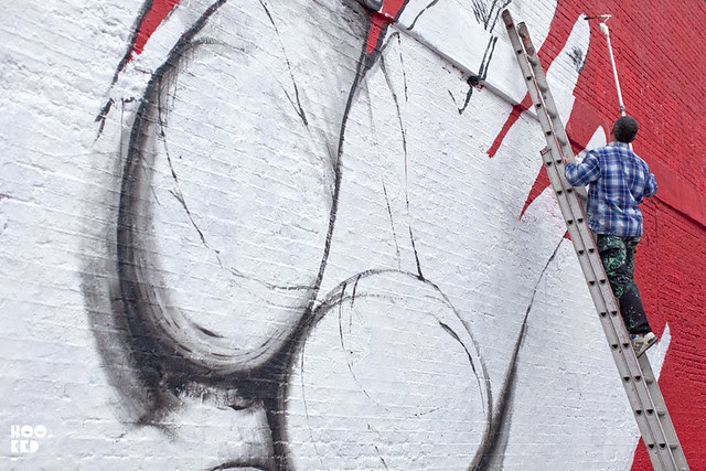 Italian street artist Run paints a new mural on East London's iconic Village Underground Wall. Italian street artist Run paints a new mural on East London's iconic Village Underground Wall.