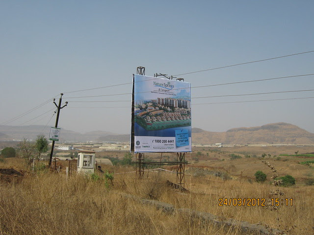 Visit Vascon Nature Springs Villas Row Houses 2 BHK & 3 BHK Flats & Vascon Nature's Nest 1 BHK 1.5 BHK & 2 BHK Flats at Varale near Talegaon Dabhade Taluka Maval District Pune 410 507 - Hoarding at the site