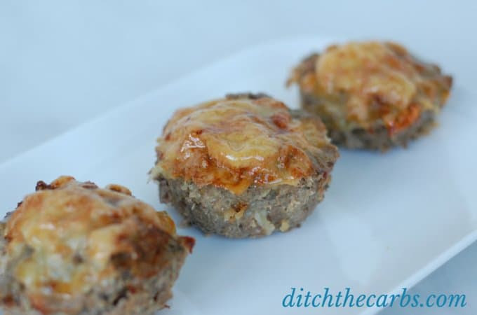 A fabulous recipe for meatloaf cupcakes. Topped with melted cheese makes these little bundles  a great snack idea, lunch or for the school lunch boxes. Make a double batch and freeze them so you're ready for the next few weeks. Gluten free, grain free and low carb. | ditchthecarbs.com