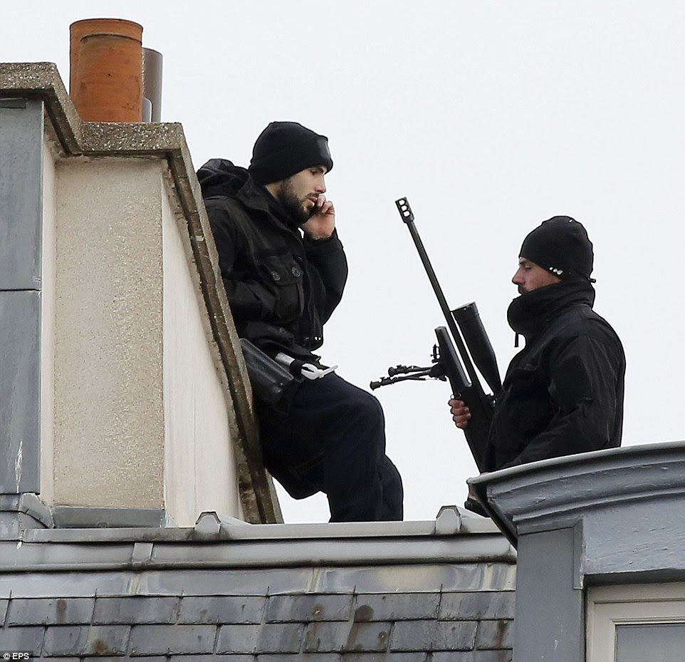 Snipers patrol the meeting at the Elysee Palace in Paris where President Francois Hollande was holding an emergency security meeting