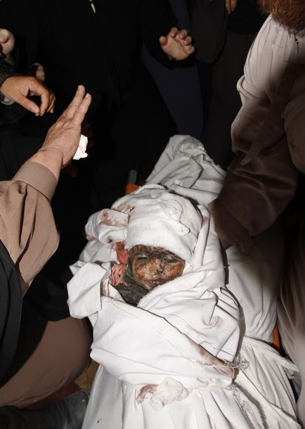Palestinian relatives mourn over the bod
