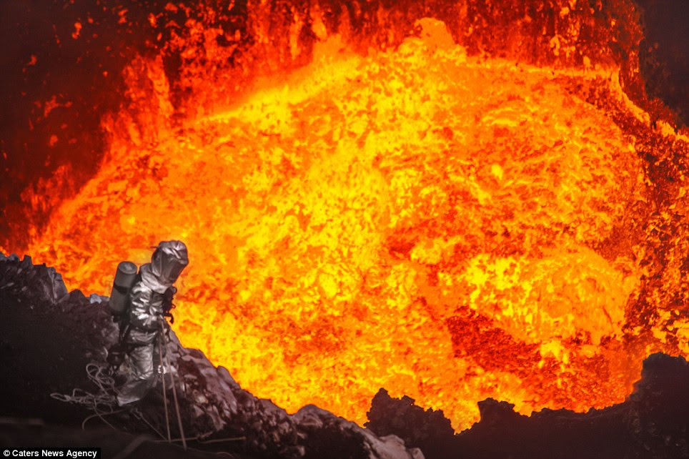 Staring into hell: Mr Mackley peers into the raging Marum Volcano, on the island of Vanuatu, in the South Pacific as he abseils into the heart of the crater