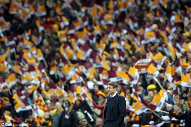 Flags: Phil Parkinson looks on as Bradford City fans continue to show their support despite being dominated