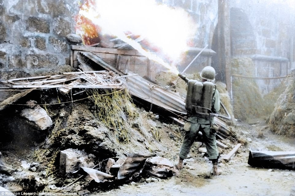 Pictured, a US soldier uses an M2 flamethrower on a Japanese position in Manila at the close of World War II in 1945