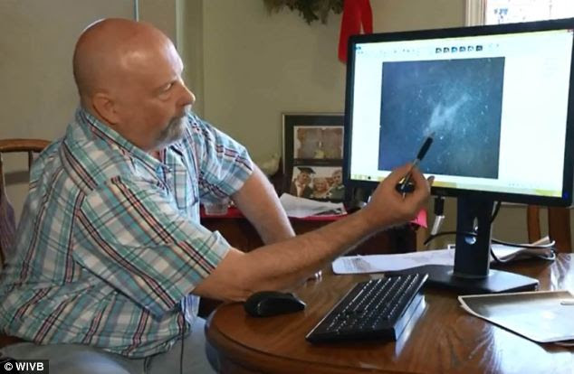 Is it the wreckage? Michael Hoebel is pictured showing an image of what he believes is the wreckage of missing Malaysia Airlines flight MH370. He found the image on a website that shares satellite images