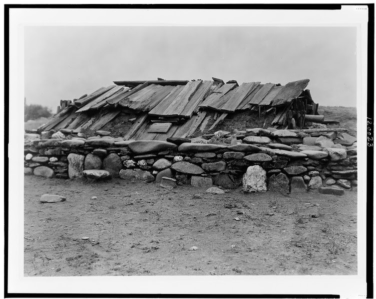 Description of  Title: Hupa sweat-house.  <br />Date Created/Published: 1923.  <br />Summary: Underground building covered with wood plank roof, surrounded by wall of large rocks.  <br />Photograph by Edward S. Curtis, Curtis (Edward S.) Collection, Library of Congress Prints and Photographs Division Washington, D.C.