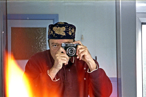 reflected self-portrait with Cosmic 35 camera and embroidered hat by pho-Tony