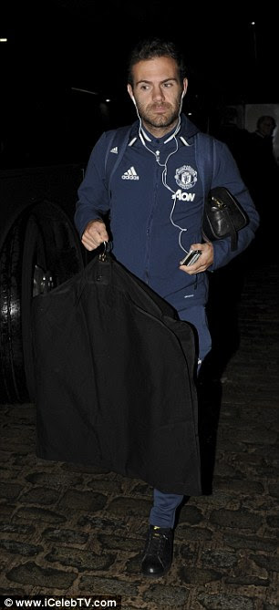 Juan Mata carries a suitbag and a washbag