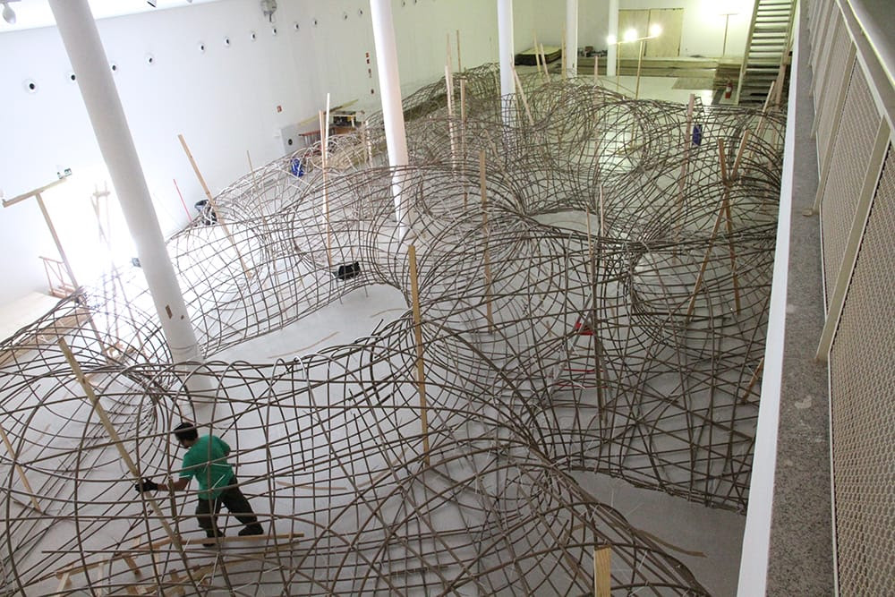 Artist Henrique Oliveira Constructs a Cavernous Network of Repurposed Wood Tunnels at MAC USP Artist Henrique Oliveira Constructs a Cavernous Network of Repurposed Wood Tunnels at MAC USP wood installation architecture