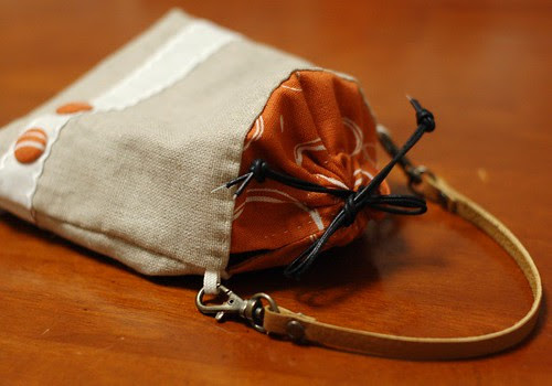Petit pouch with a leather strap