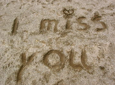 words I miss you written in sand
