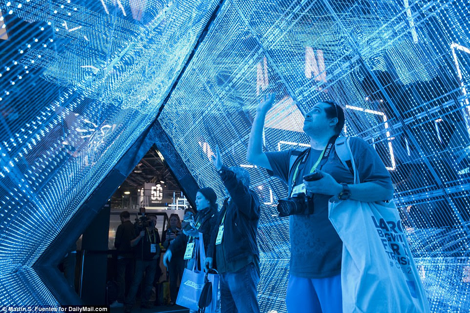 Once exhibitors were able to get the lights back on, stunning displays were once again back in action. Pictured, attendees step inside the immersive LED tunnel that brings 5G to life