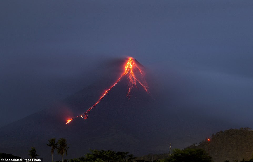 Lava is continuing to cascade down the slopes of Mayon volcano as seen from Legazpi city, Albay province, about 210 miles south-east of Manila