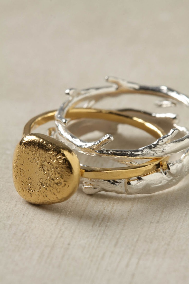http://www.pinterest.com/pin/150307706282986790/ Nesting Ring Set of three rings: Silver branch and twig nestle around a bright, gilded pebble #jewelry #stacking #rings