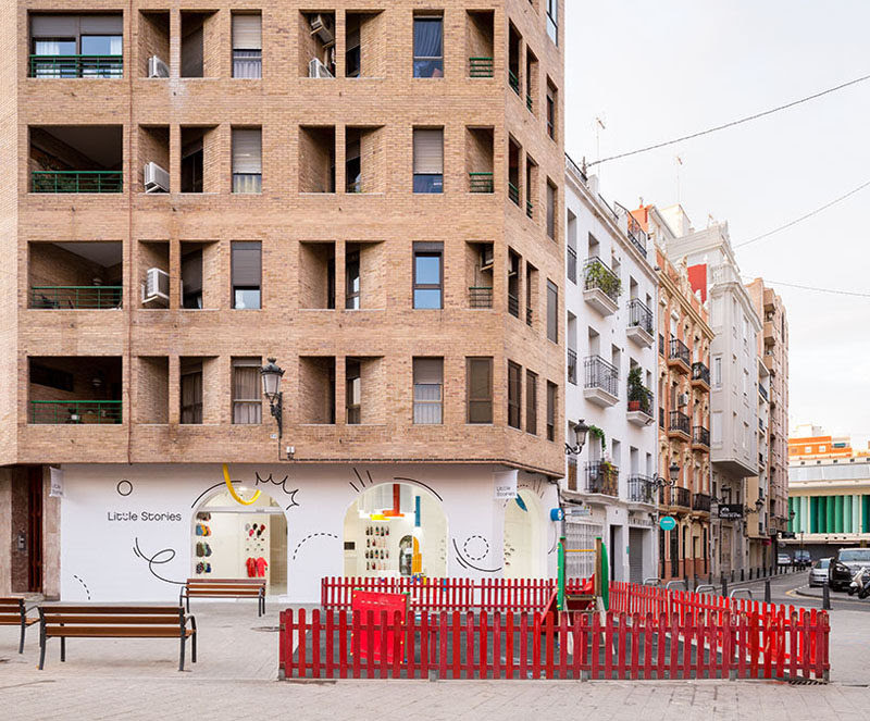 Creative firm CLAP Studio have designed "Little Stories", a modern children's shoe store in Valencia, Spain, that stands out on the street with its bright white facade and interior. #RetailStore #WhiteFacade #StoreDesign