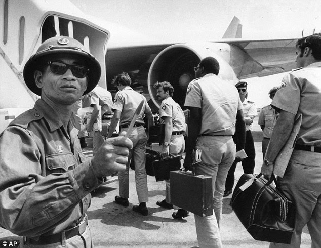 Viet Cong: In this March 28, 1973 photo, a Viet Cong observer of the Four Party Joint Military Commission counts U.S. troops as they prepare to board jet aircraft at Saigon's Tan Son Nhut airport