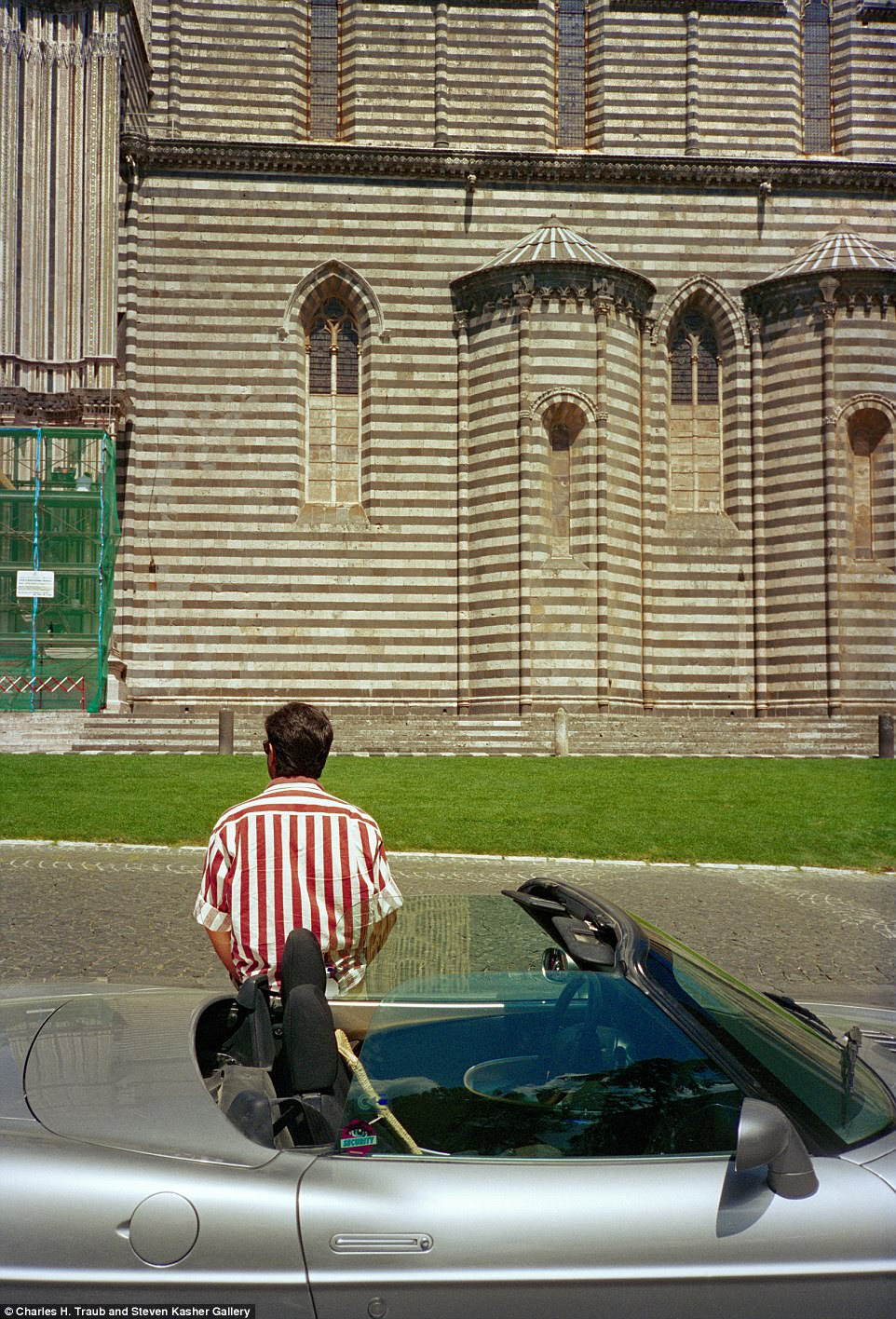 A suave gentleman leans on his sports car outside Orvieto Cathedral in Umbria in 1989