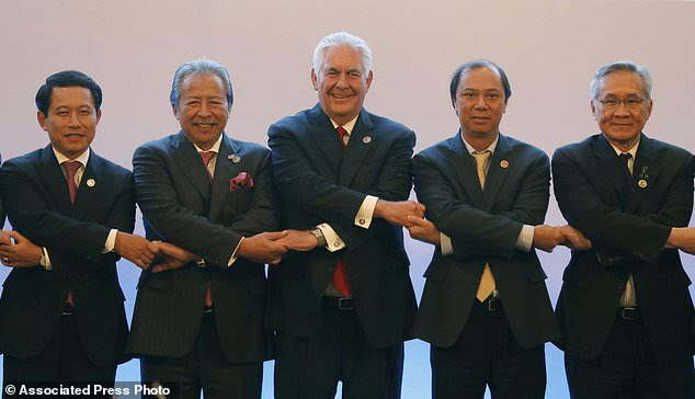 U.S. State Secretary Rex Tillerson, center, links arms with ASEAN foreign ministers as they take part in the ASEAN-U.S. Ministerial meeting in the 50th Association of Southeast Asia Nations in Manila on Sunday