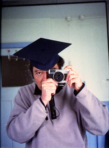 reflected self-portrait with Fujica D1 camera and mortar board by pho-Tony